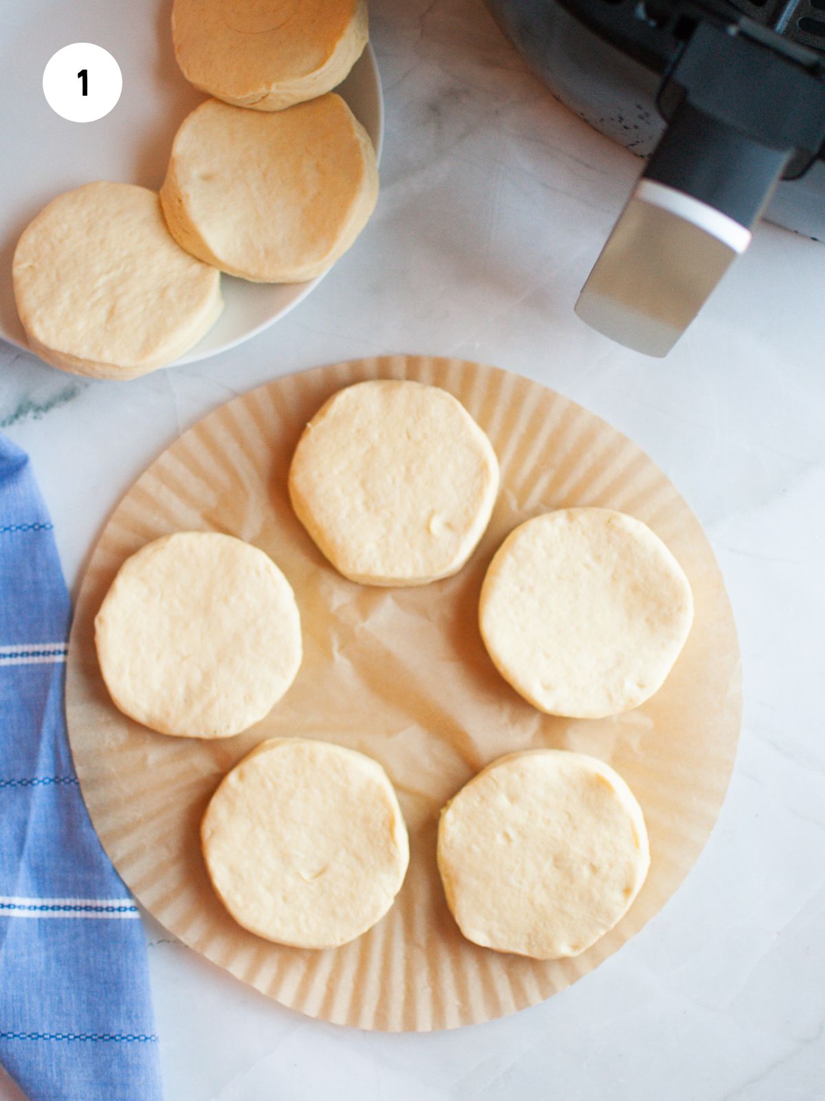 biscuit dough on a round piece of parchment