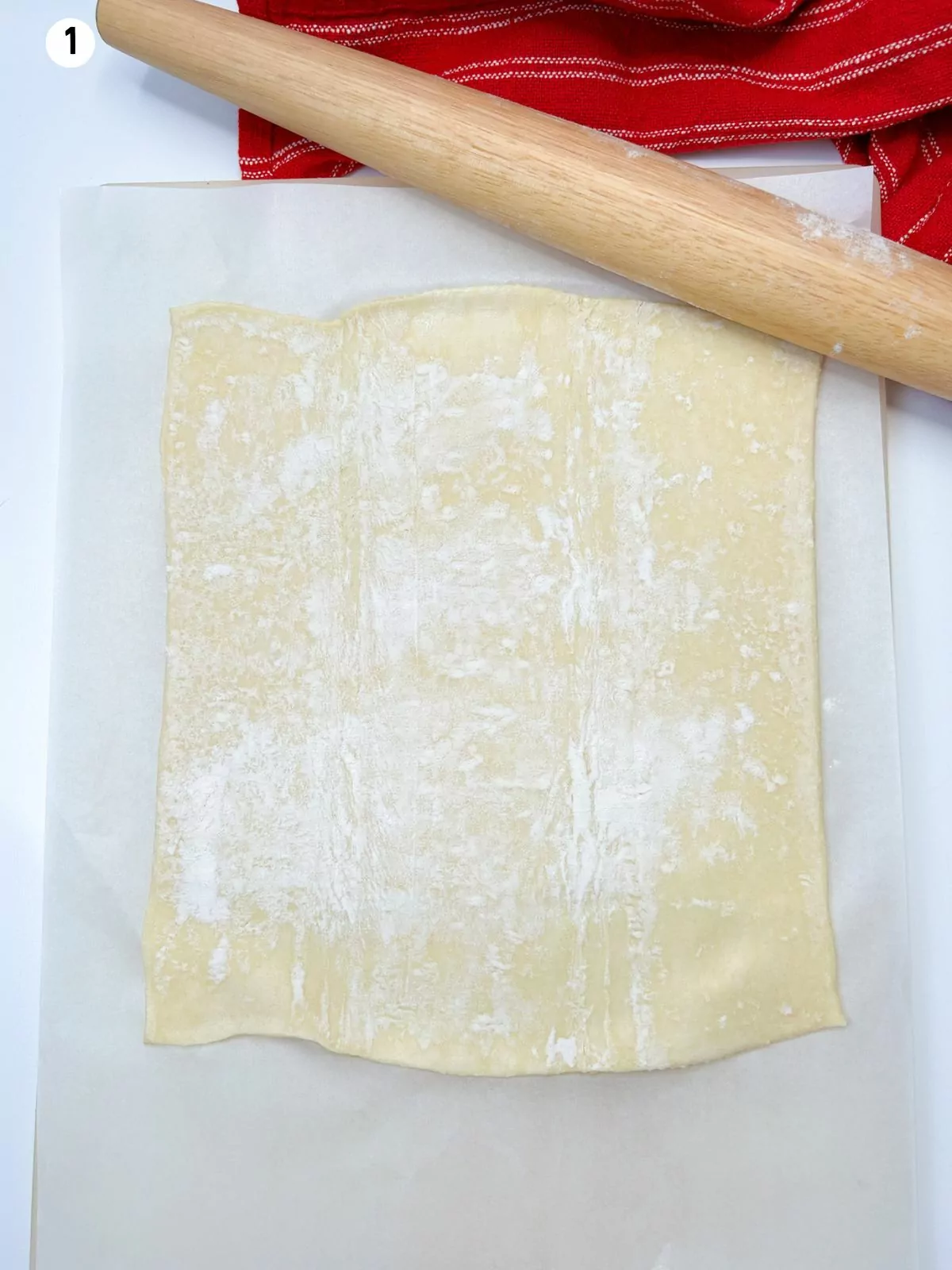 rolled out puff pastry with a wood rolling pin