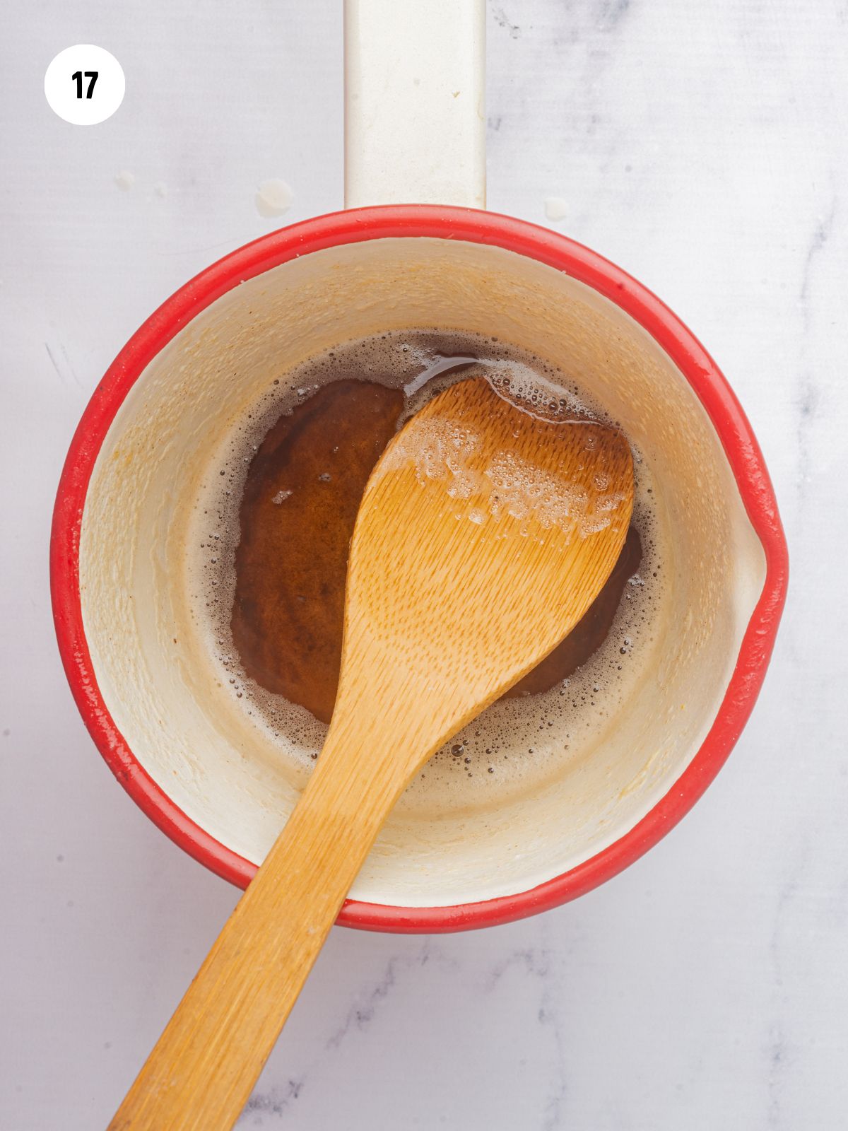 brown butter and wooden spoon in a red saucepan