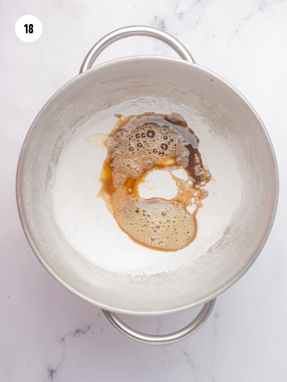 butter and powdered sugar in a stainless steel mixer bowl