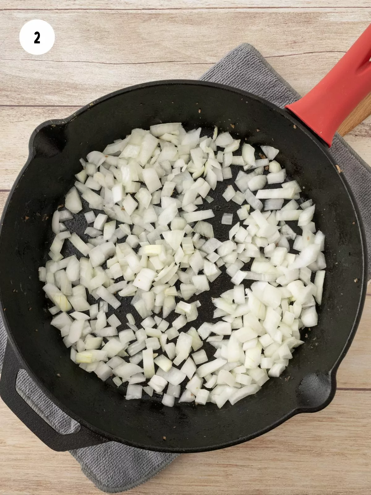 diced onion in an iron skillet