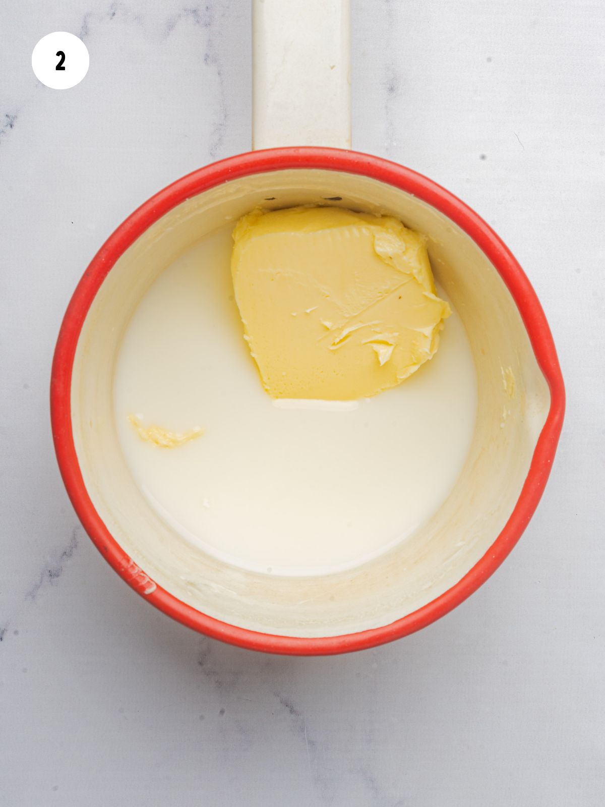 milk and butter in a red saucepan