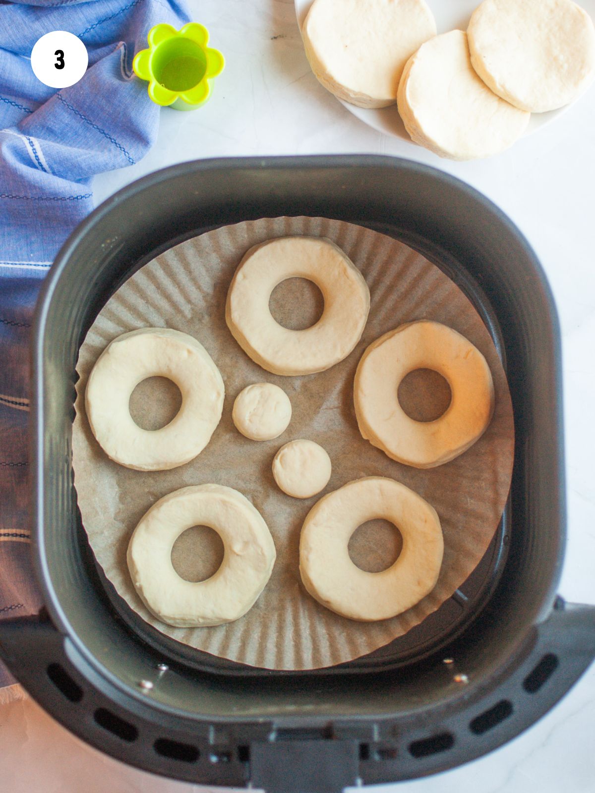 donut and donut hole dough in air fryer basket