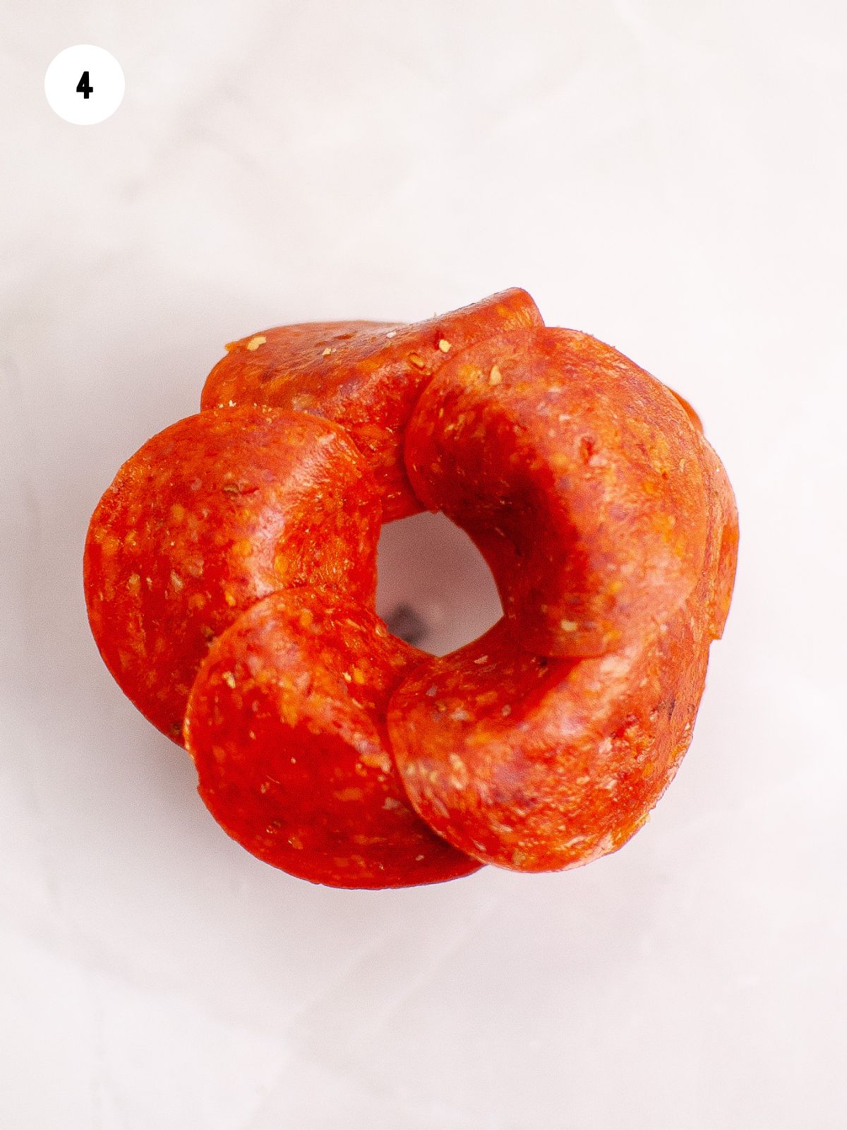 pepperoni overlapping on cup to make rose