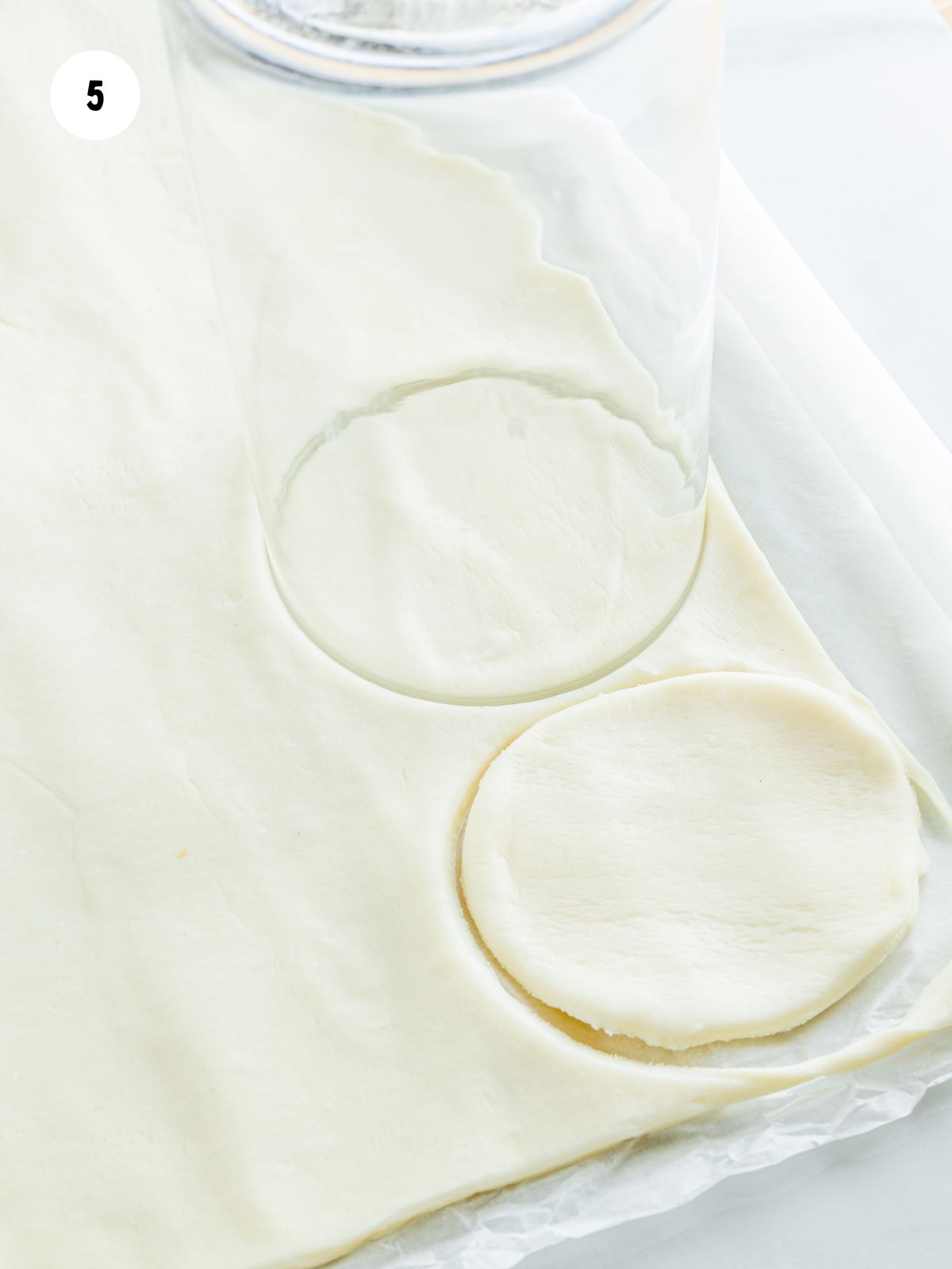 circles cut in puff pastry with a glass