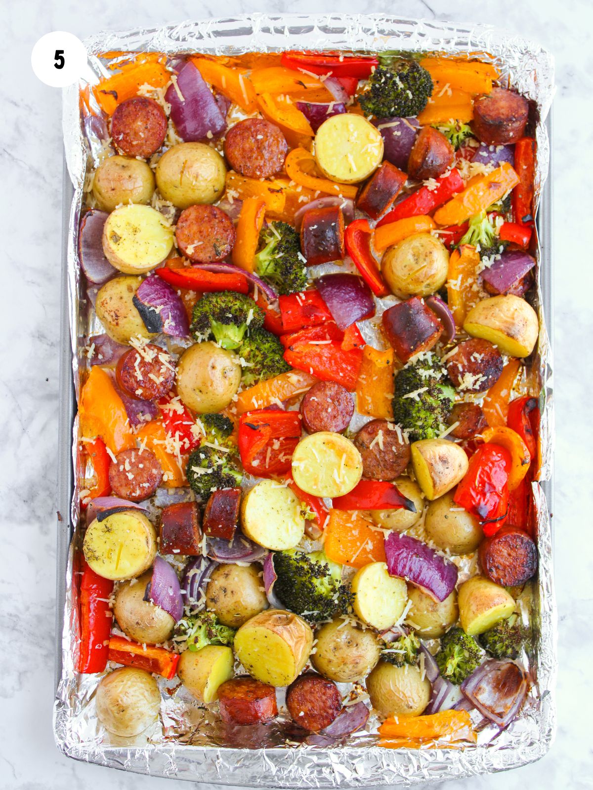 cooked sausage and veggies on a sheet pan