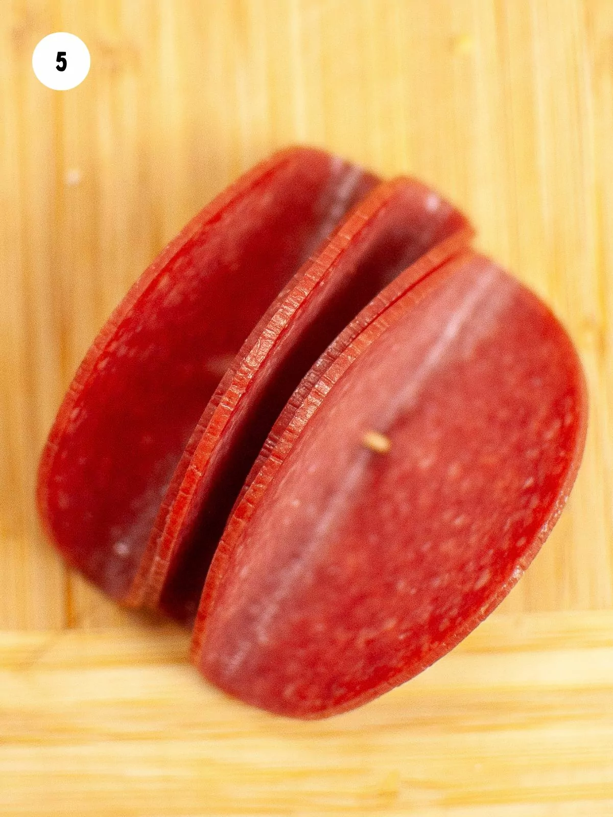 slices of salami folded in half on a toothpick