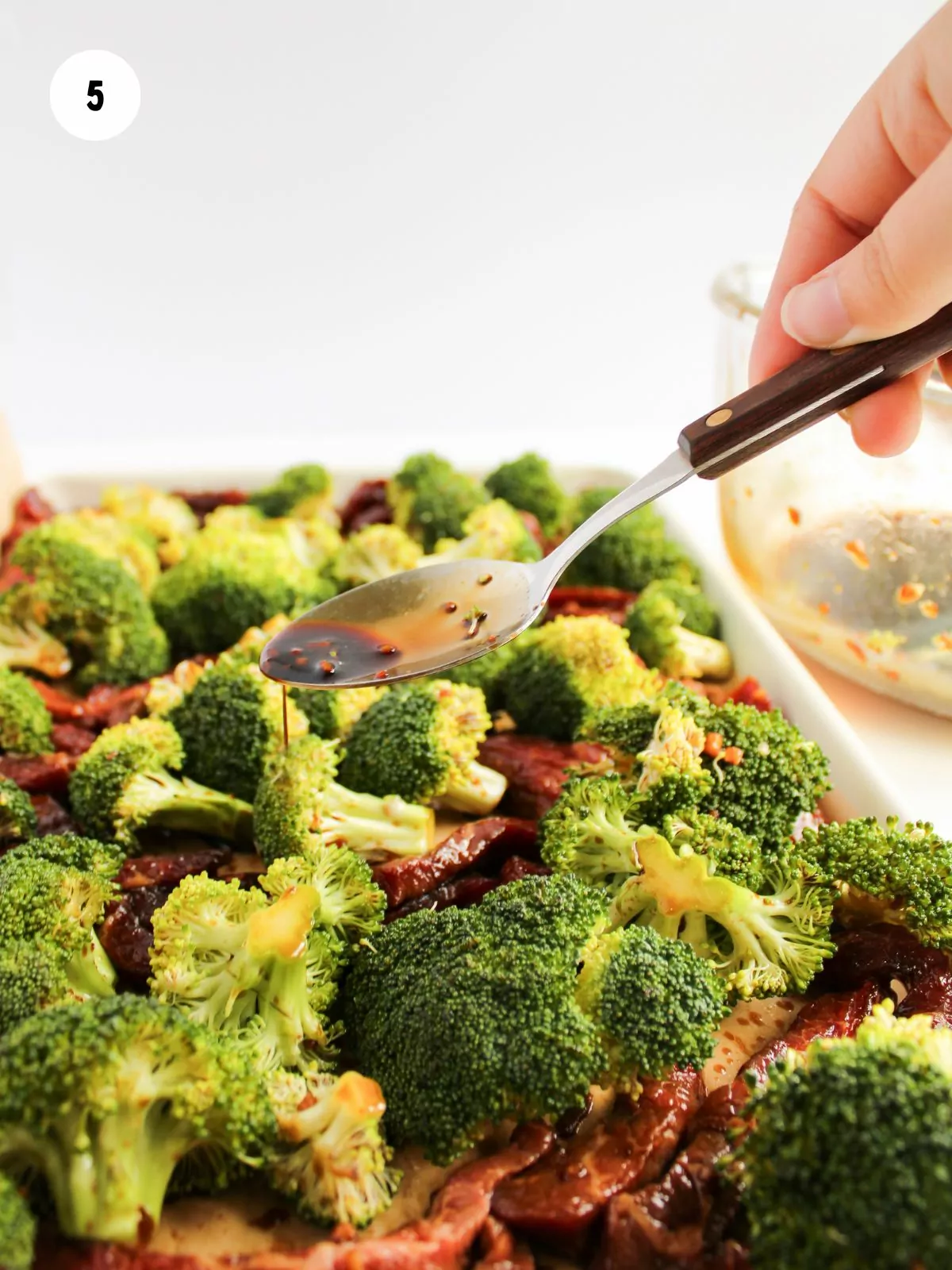 remaining marinade being spooned over the beef and broccoli