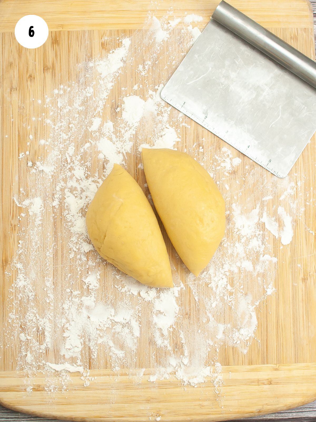dough cut in half with a bench scraper