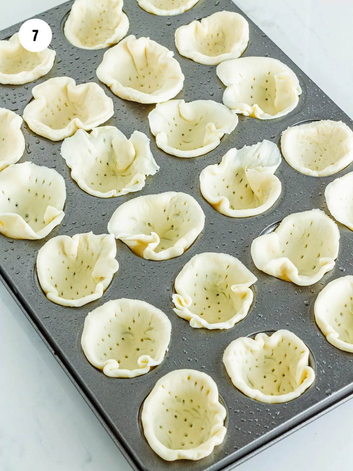 puff pastry circles pressed in mini muffin pan