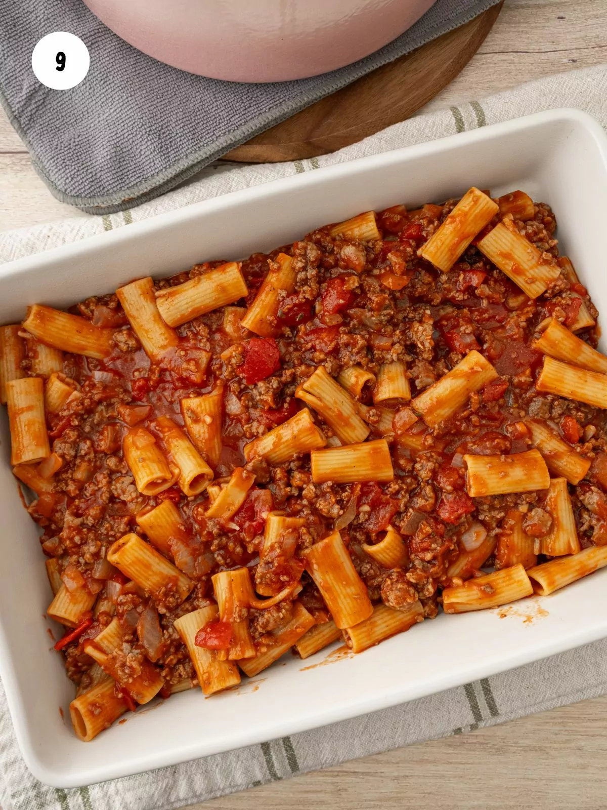 pasta and sauce in the bottom of a baking dish