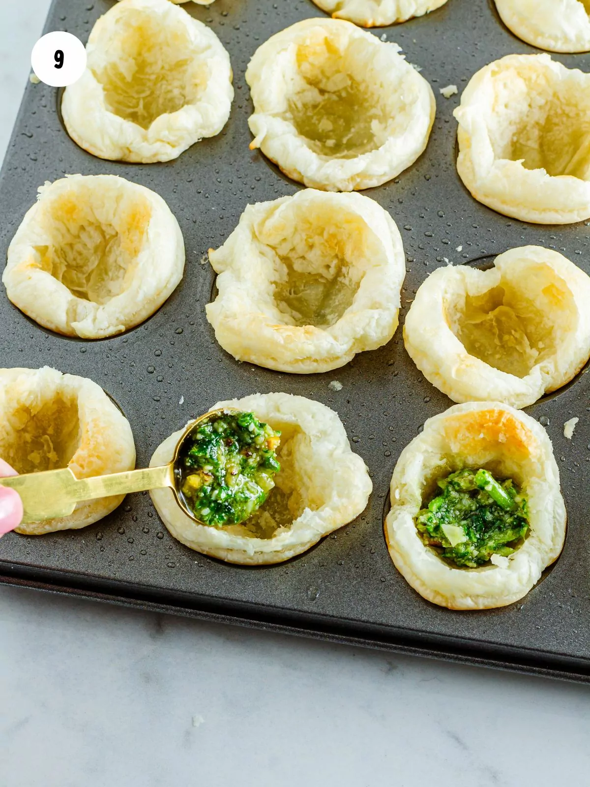 pesto scooped into puff pastry cups