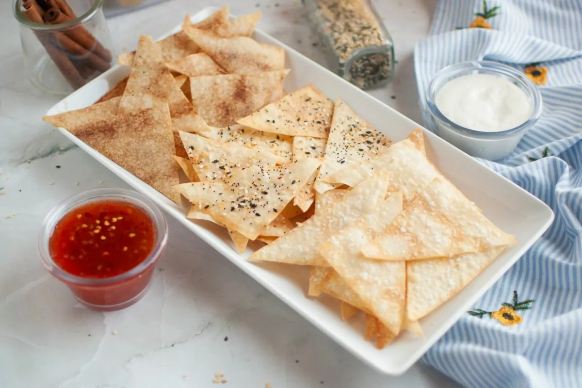 Air Fryer Wonton Chips flavored with cinnamon sugar, everything seasoning, and sea salt. Dipping sauces in small cups next to the platter.