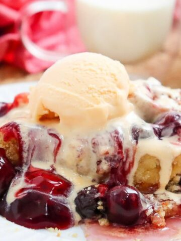 Cherry Dump Cake with a scoop of ice cream melting on top