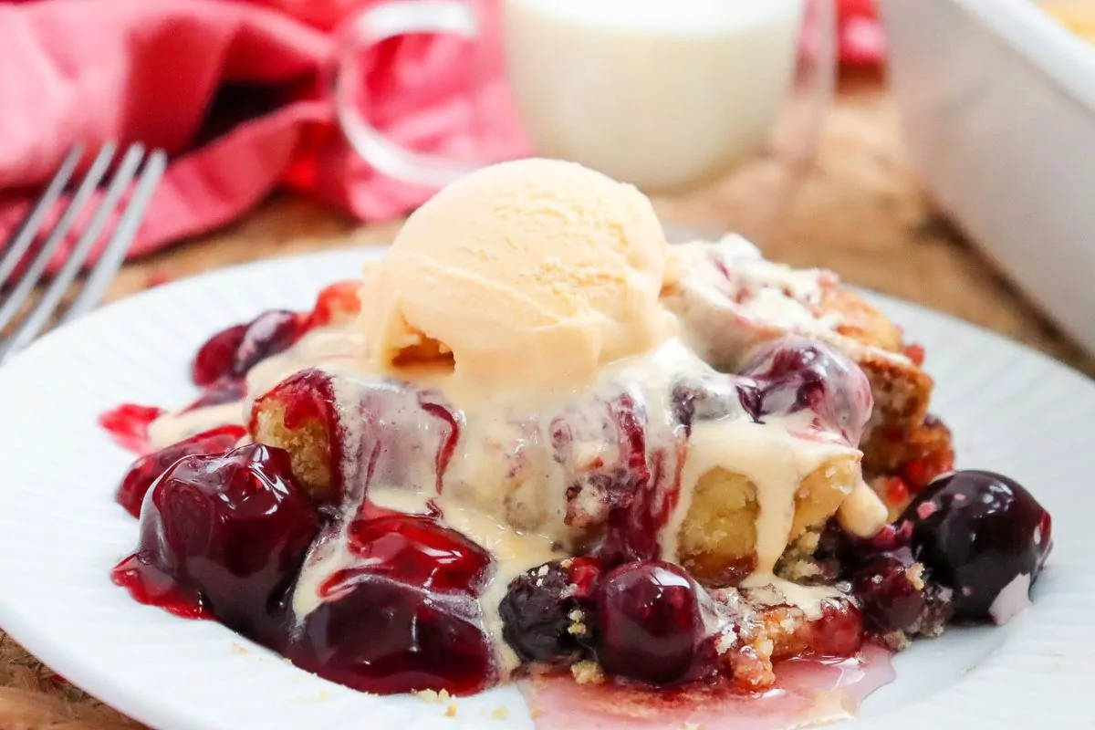 Cherry Dump Cake with a scoop of ice cream melting on top