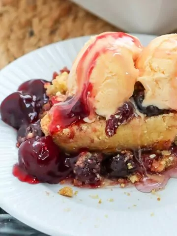 Cherry Dump Cake with scoops of ice cream on top