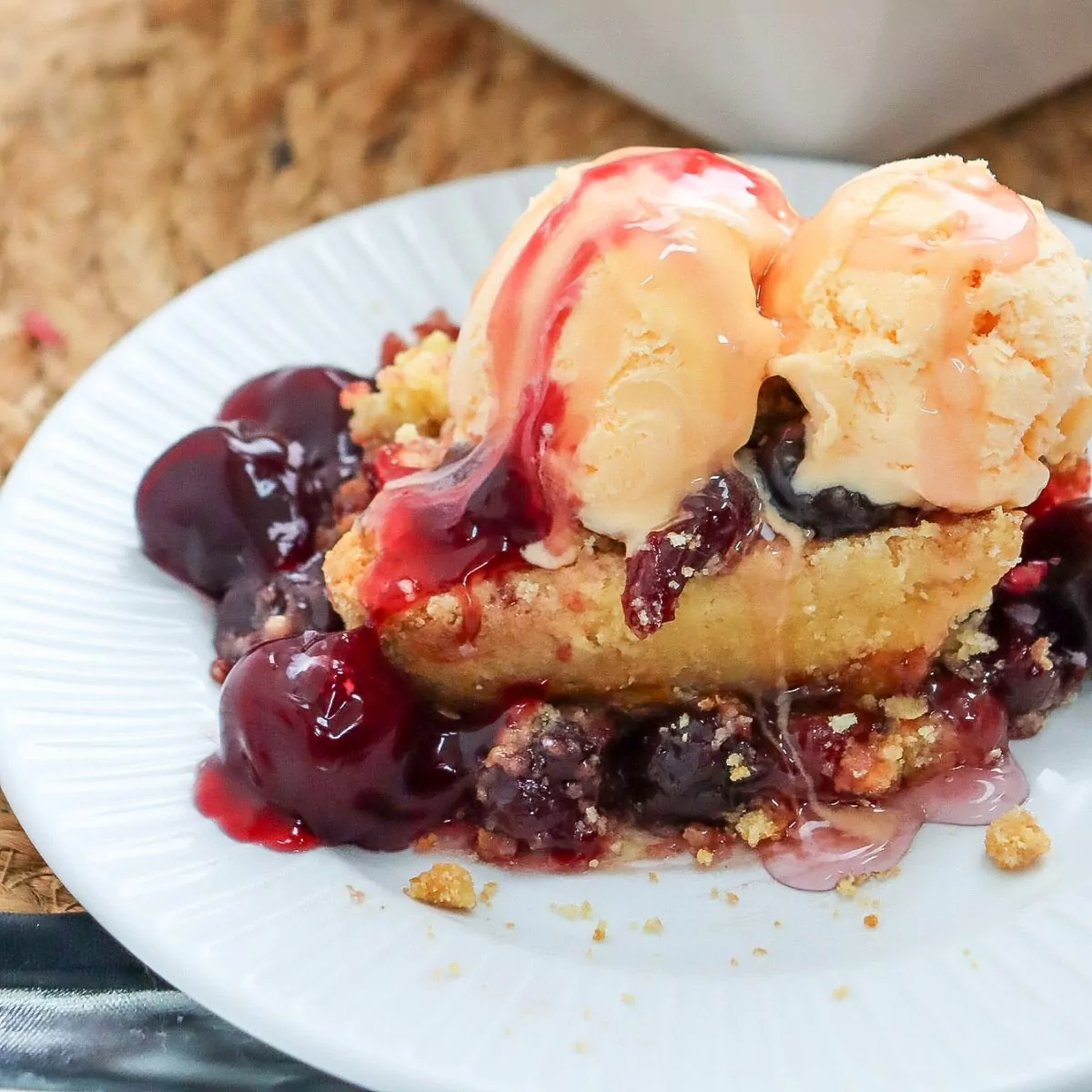 Cherry Dump Cake with scoops of ice cream on top