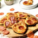 Mini Heart Shaped Pizzas on a round wooden board