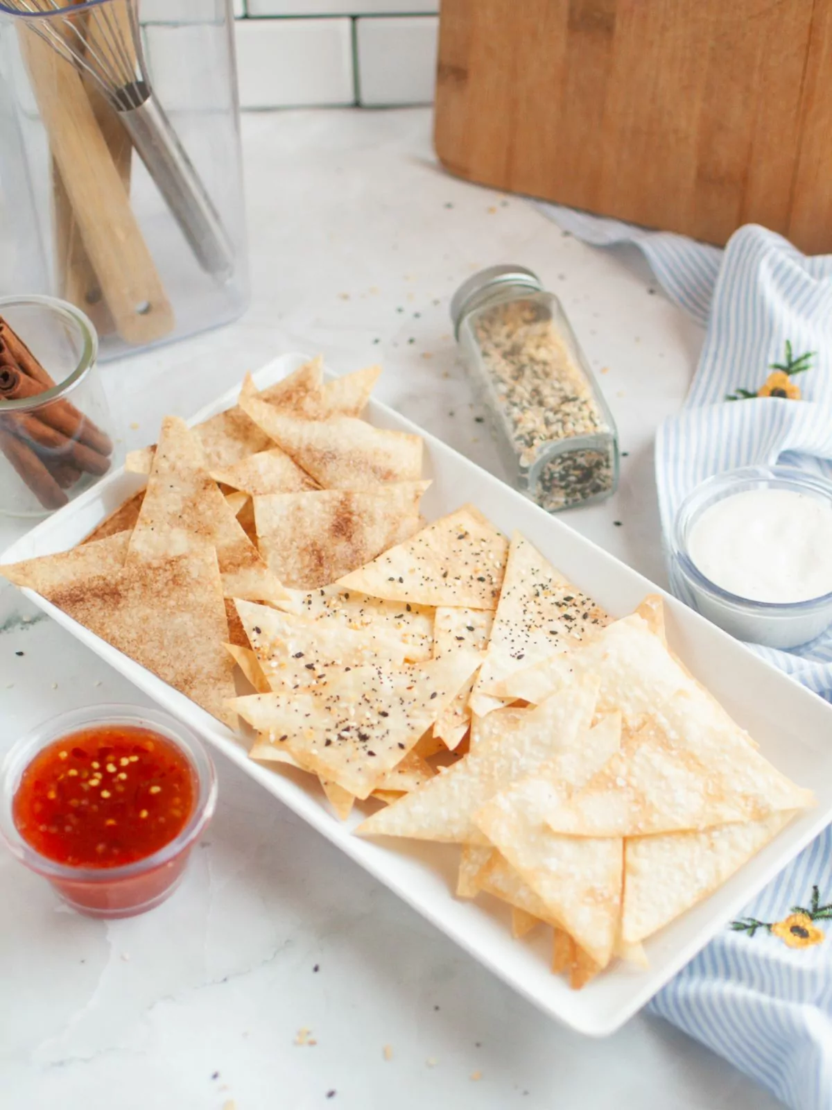 Air Fryer Wonton Chips flavored with cinnamon sugar, everything seasoning, and sea salt. Dipping sauces in small cups next to the platter.