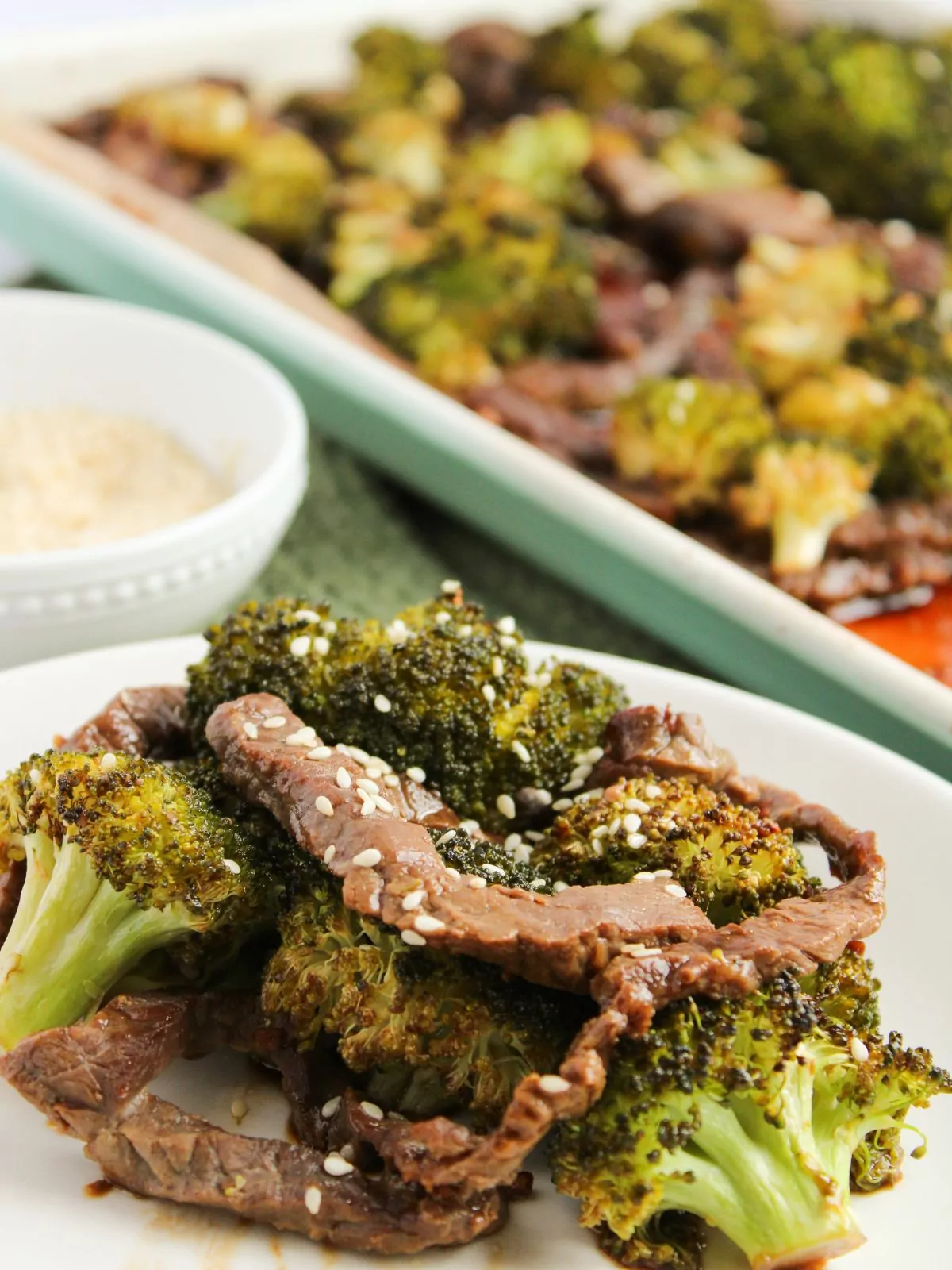 plate of beef and broccoli served and pan in the background