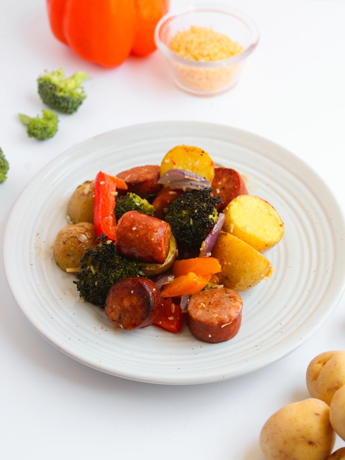 cooked sausage and veggies on a white plate