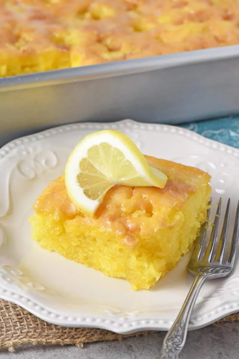 lemon cake in a plate topped with slice of lemon