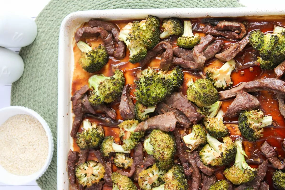 Sheet Pan Beef and Broccoli. Bowl of rice and salt and pepper shakers on the left