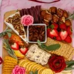 cheese, meat, olives and crackers snack board.