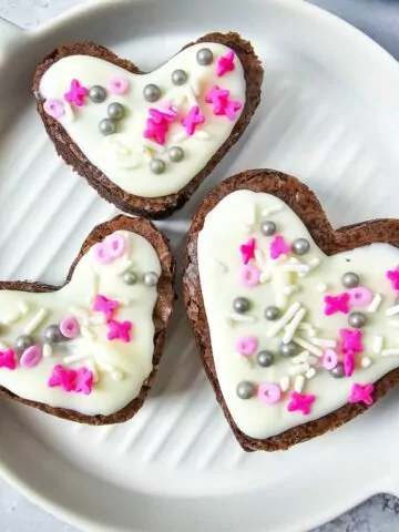 square photo of 3 brownies decorated for Valentine's Day.