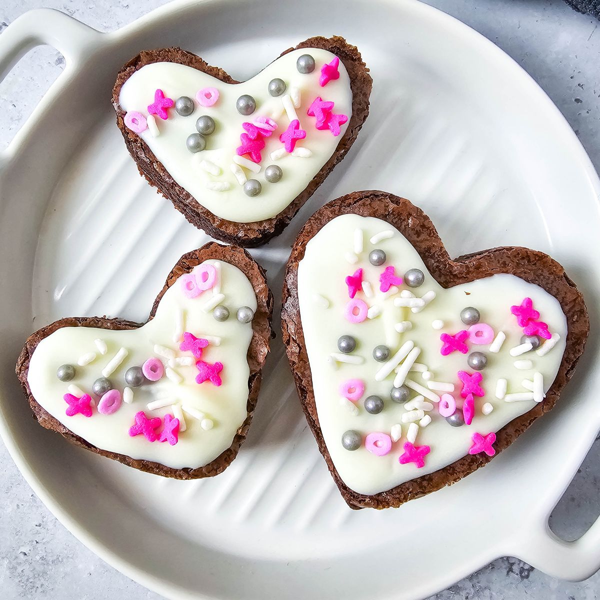 square photo of 3 brownies decorated for Valentine's Day.