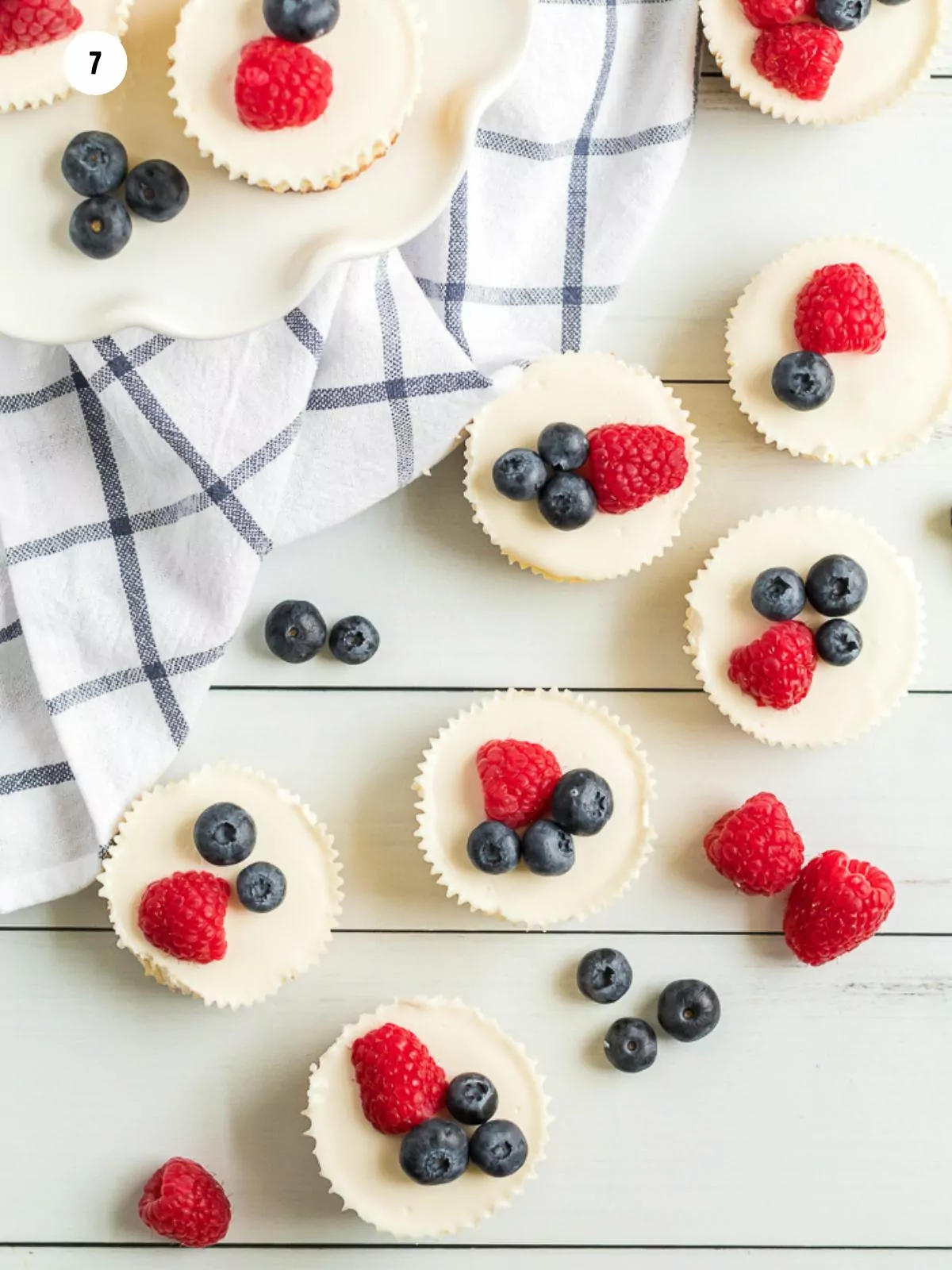 fresh raspberries and blueberries to the top of baked individual cheesecakes.