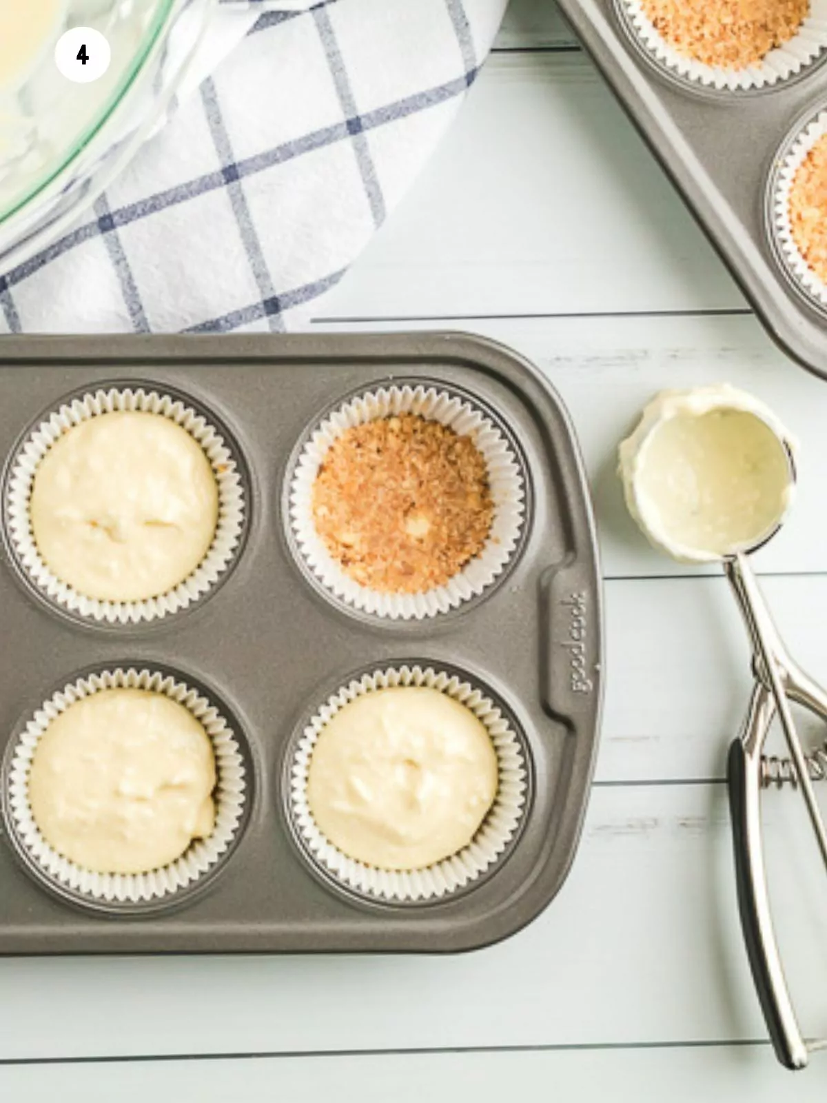 spoon cheesecake mixture in muffin pan using cookie scoop.