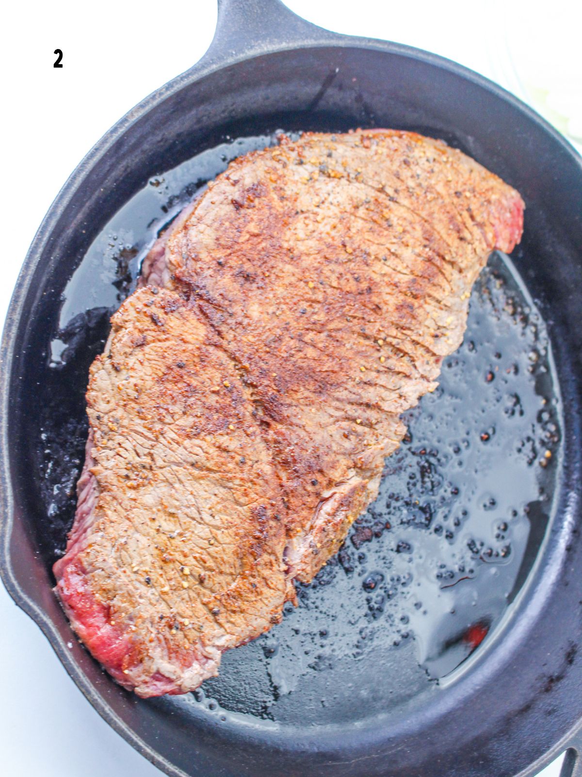 seared steak in cast iron pan