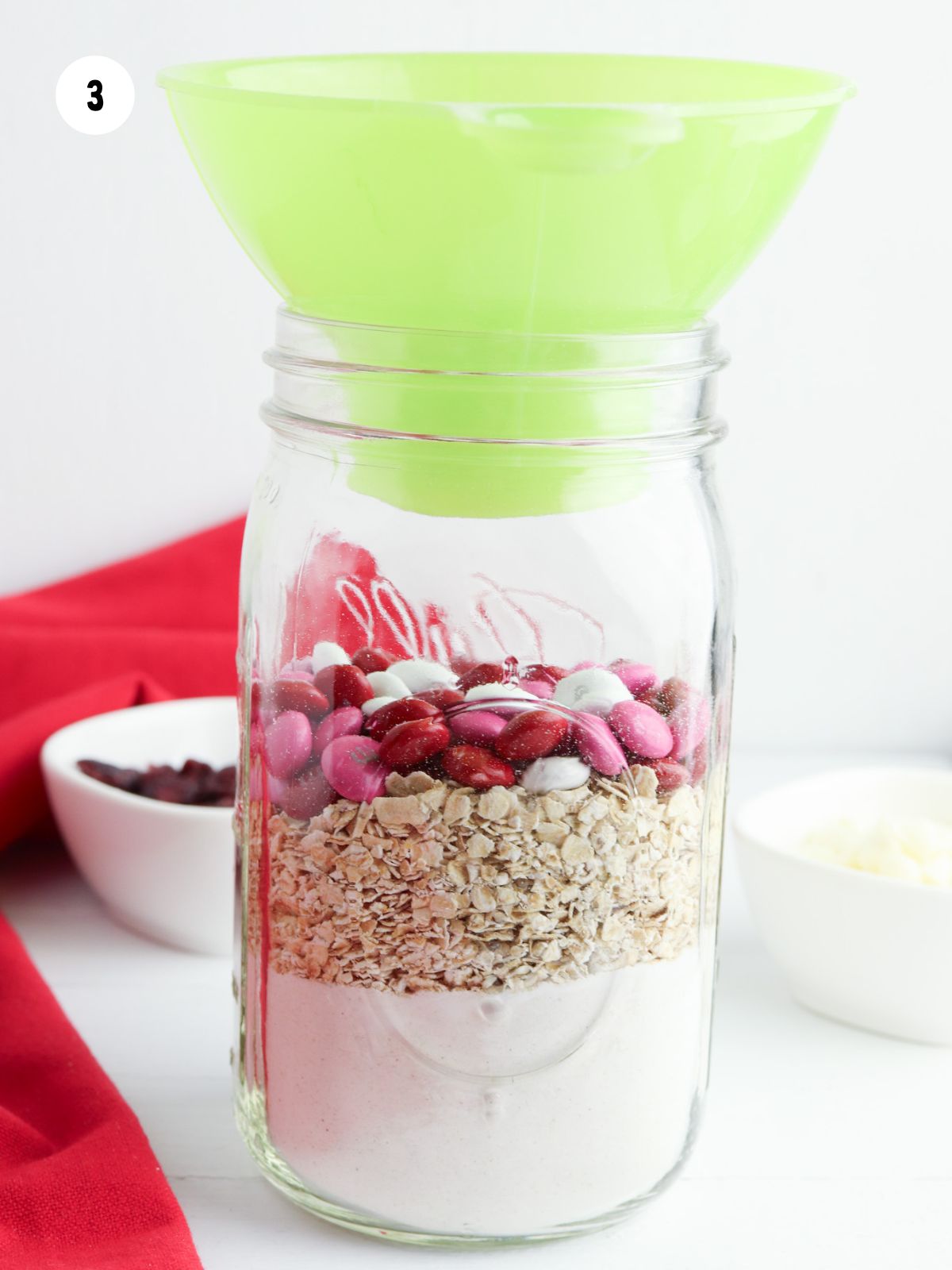 pink, red, and white M&M's layer in jar