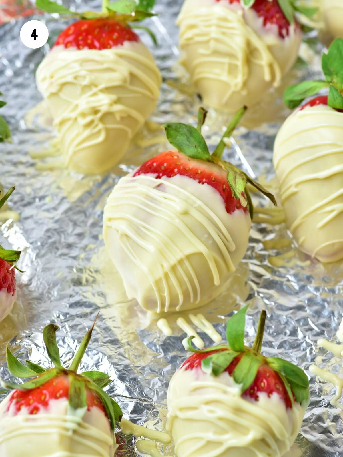 white chocolate drizzle added on dipped strawberries