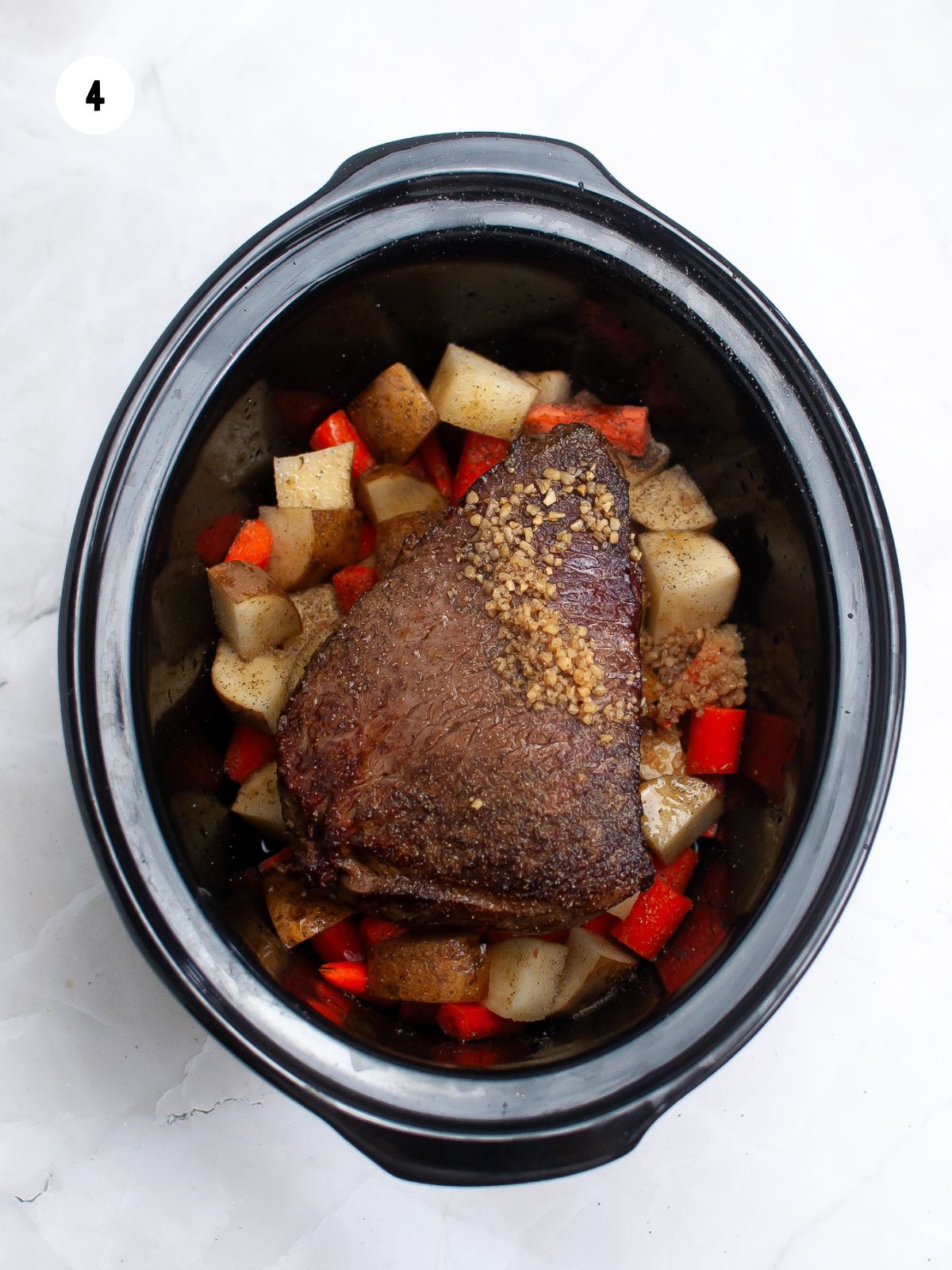 seared roast on veggies in slow cooker