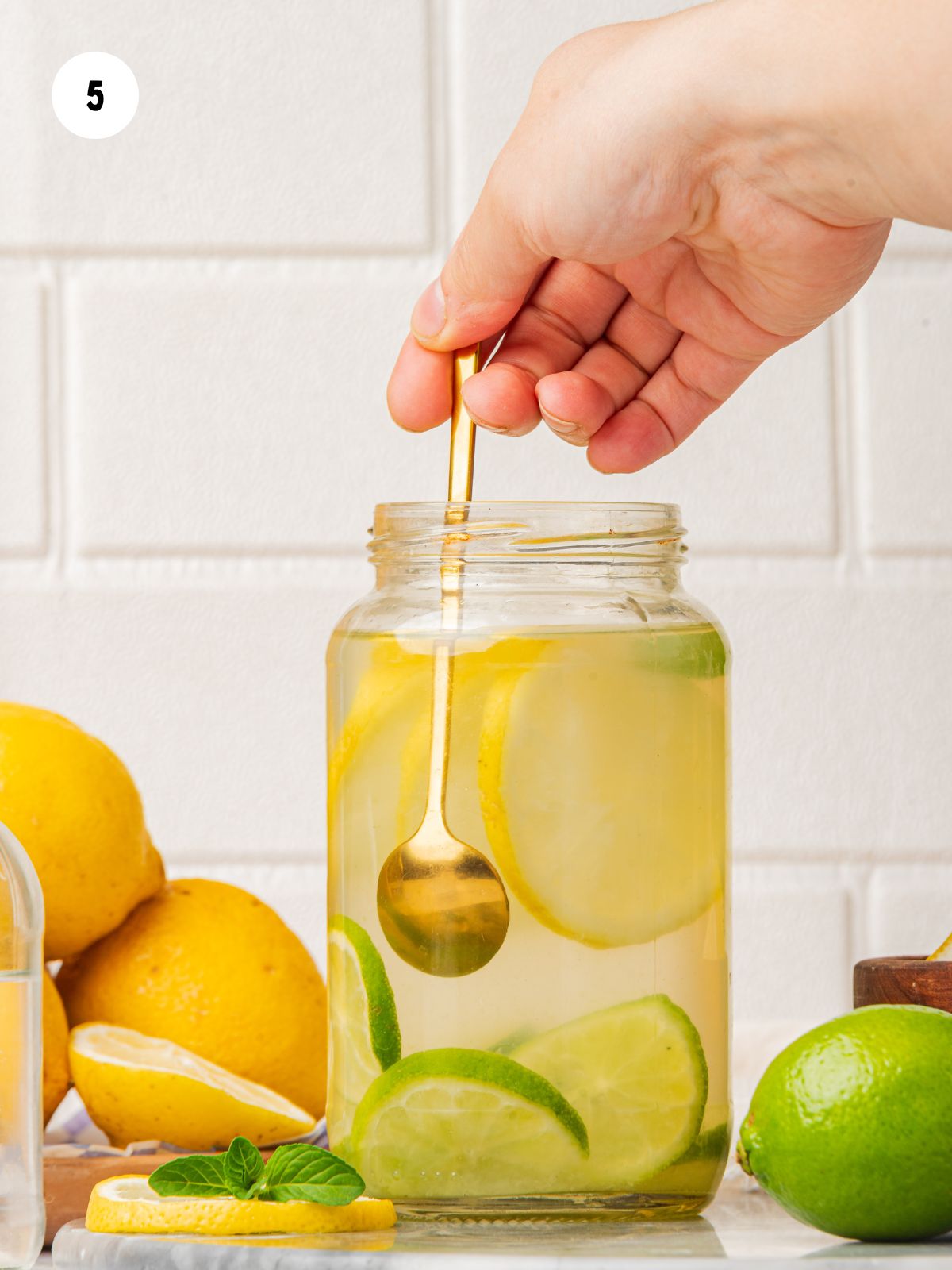 spoon stirring lemon lime water