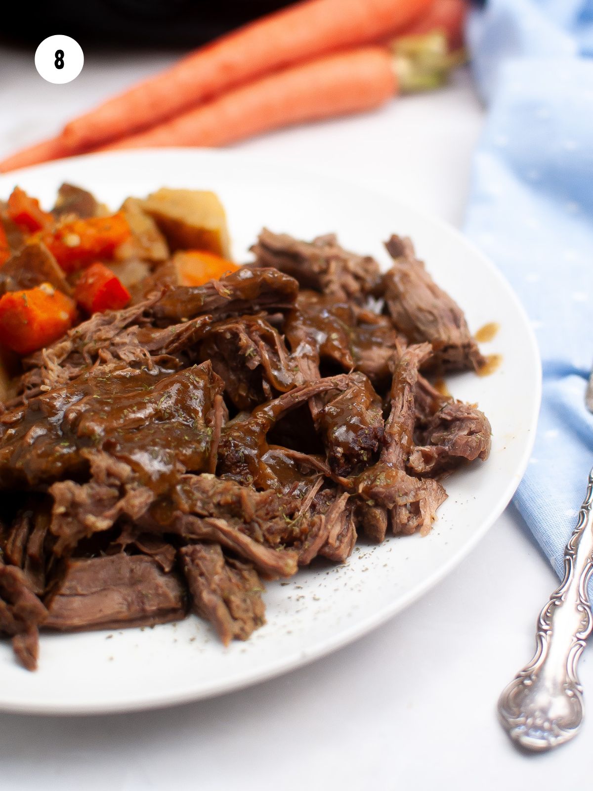 shredded beef on a white plate