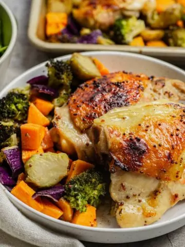 Roasted chicken and veggies served on a plate