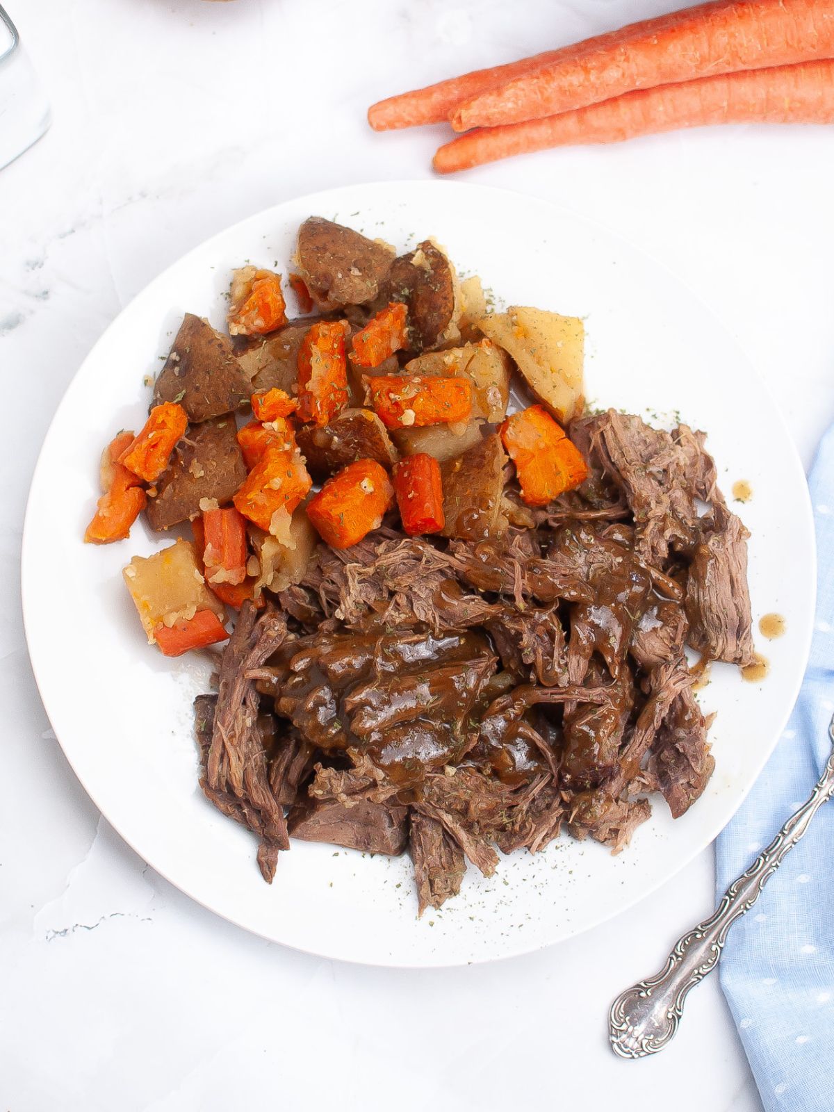 beef roast served with potatoes, carrots, and gravy
