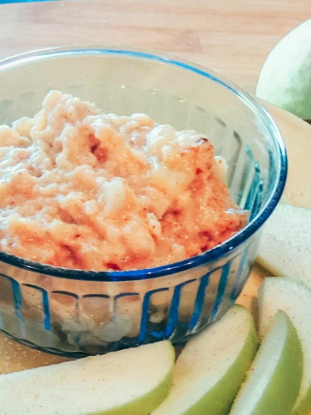 blue bowl with oatmeal and apple slices.