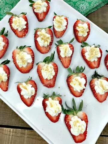 close up of hollowed out strawberries with cheesecake filling.