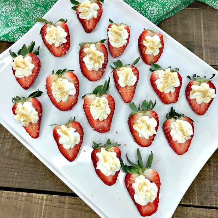 close up of hollowed out strawberries with cheesecake filling.