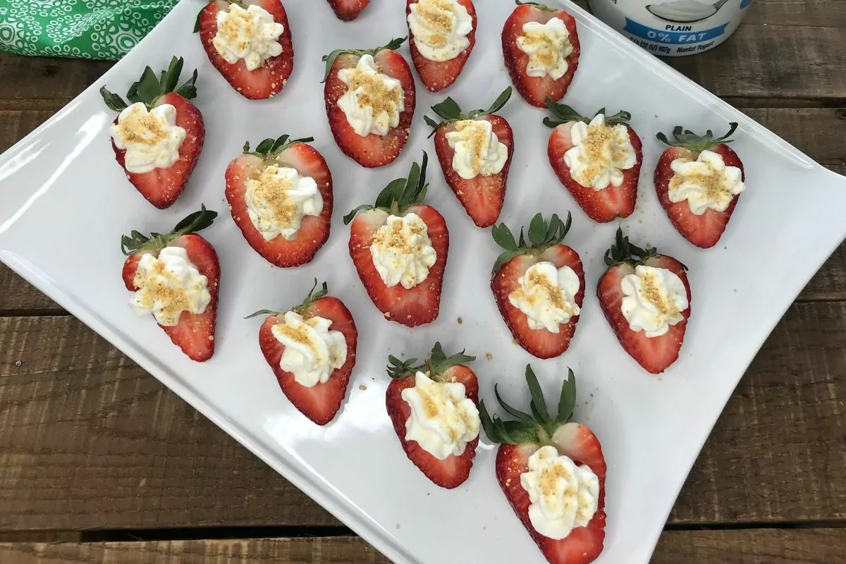 plate of halved strawberries filled with cheesecake filling MSN.