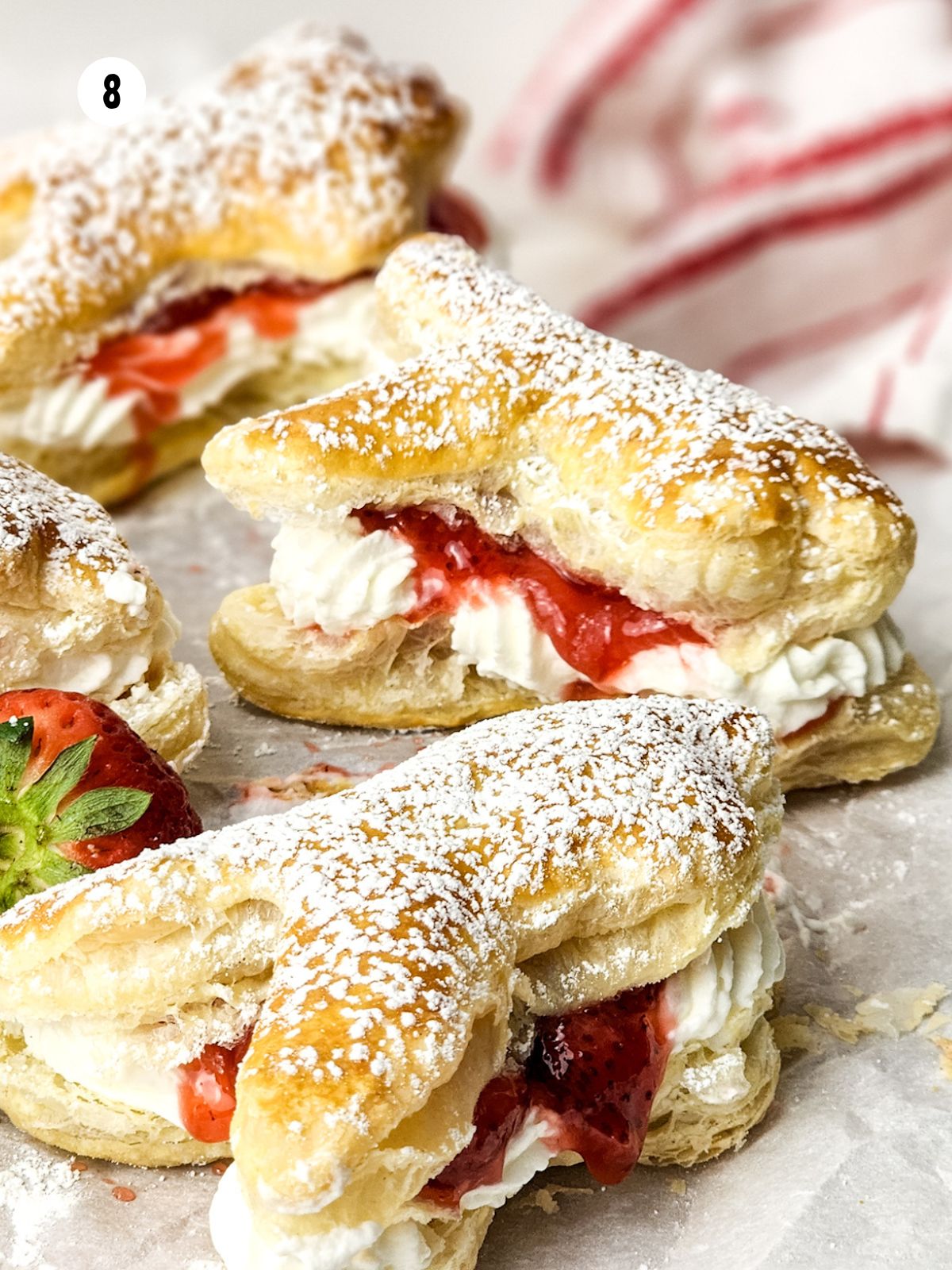 close up side view of strawberries and cream bunny puff pastries