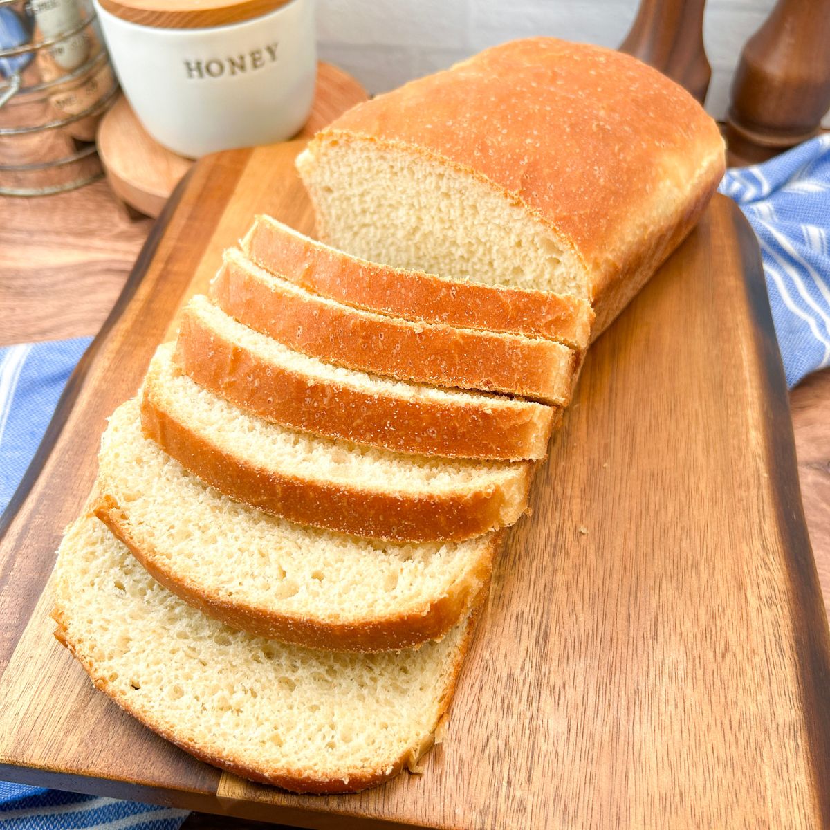 sliced white sandwich bread on a wood board