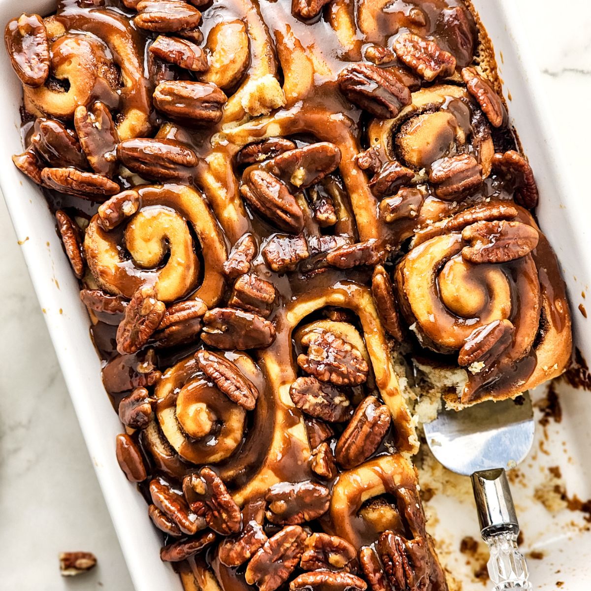 Butter Pecan Cinnamon Rolls in a white baking dish