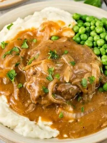 hamburger steaks with mashed potatoes and peas MSN.