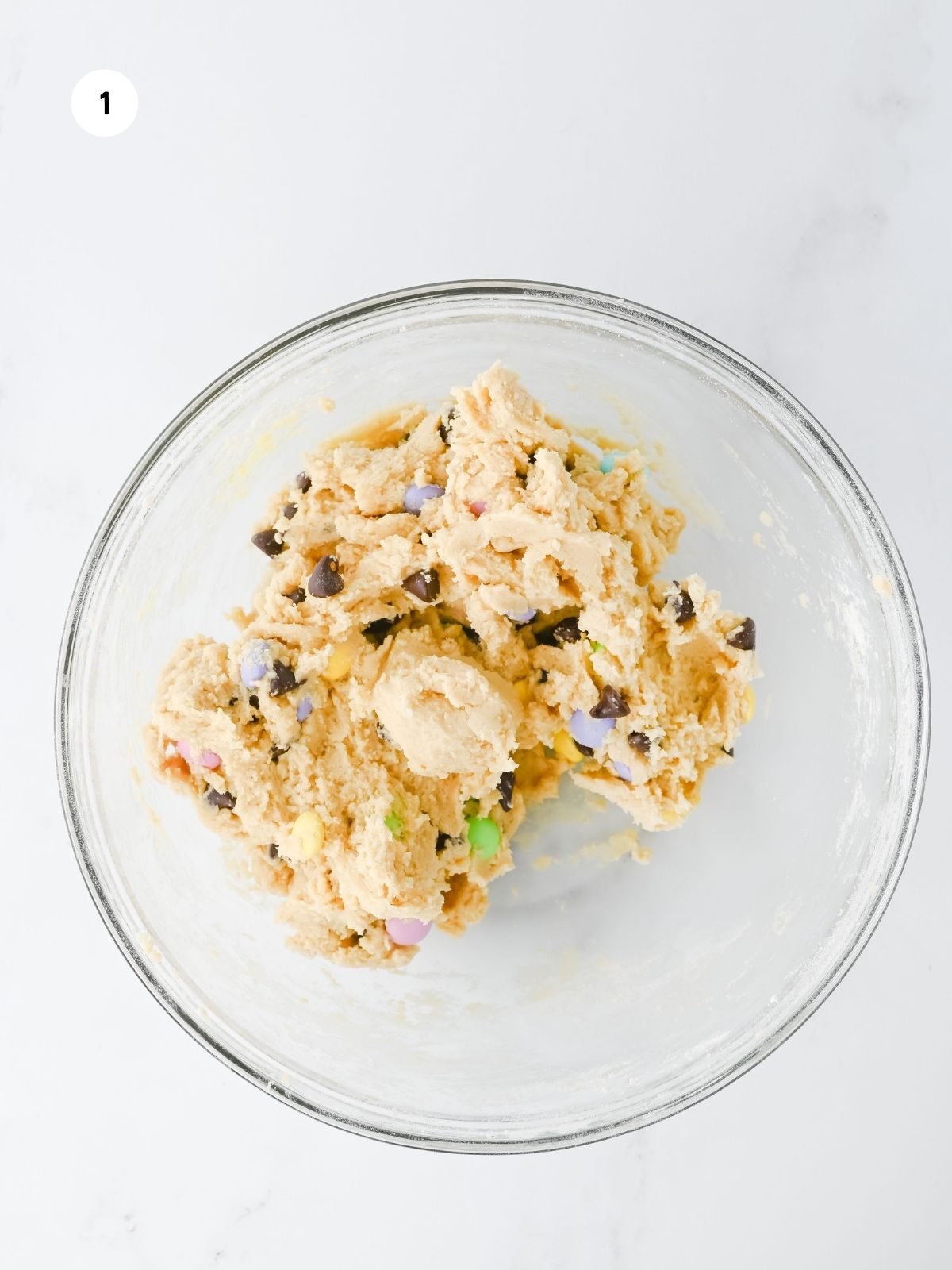cookie dough in clear mixing bowl