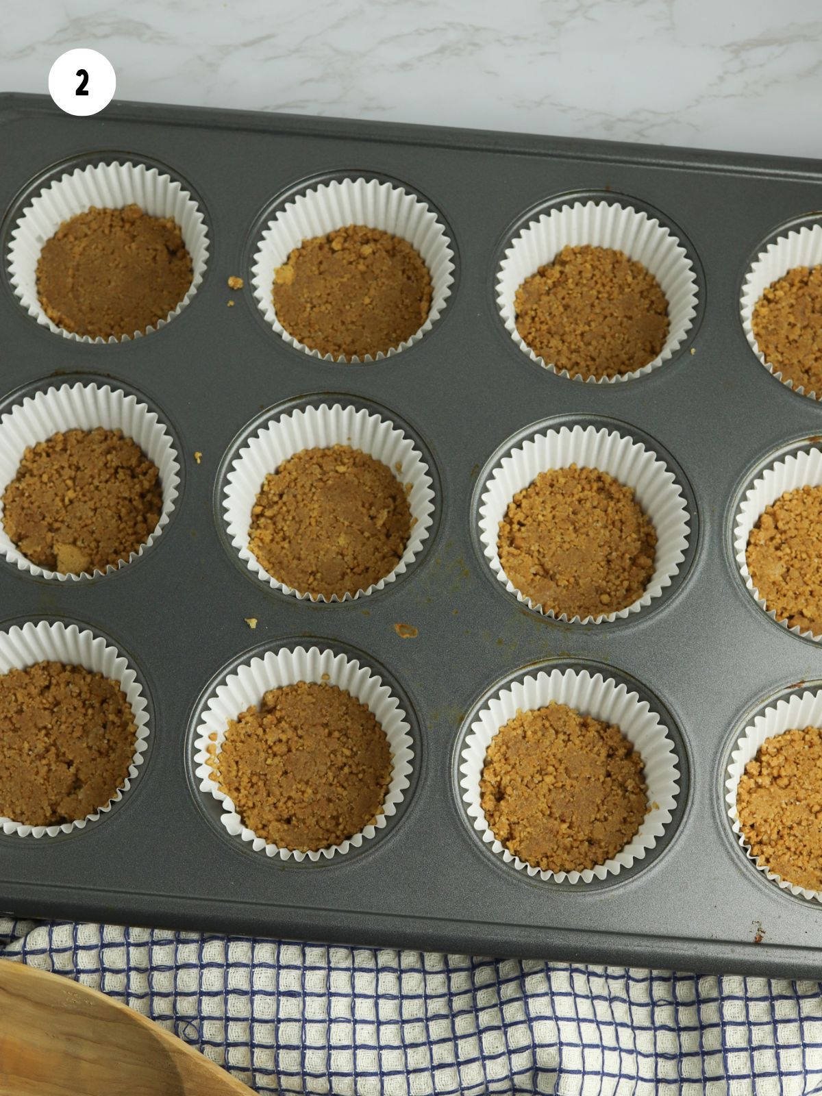 crust pressed into liners in a muffin pan
